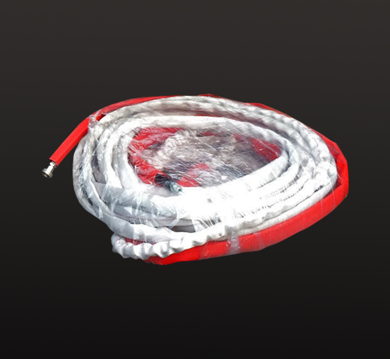 A red and white rope is laying on the ground.